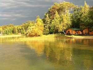 sunset on the lake shore reflecting off the Pineridge Resort Cabin